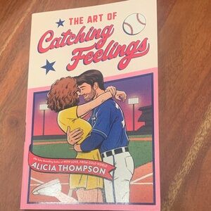 “The Art of Catching Feelings” by Alicia Thompson. Paperback romance novel